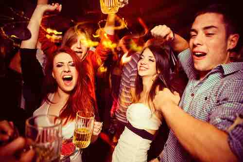 People in night club. Dancing, drinking and having fun
